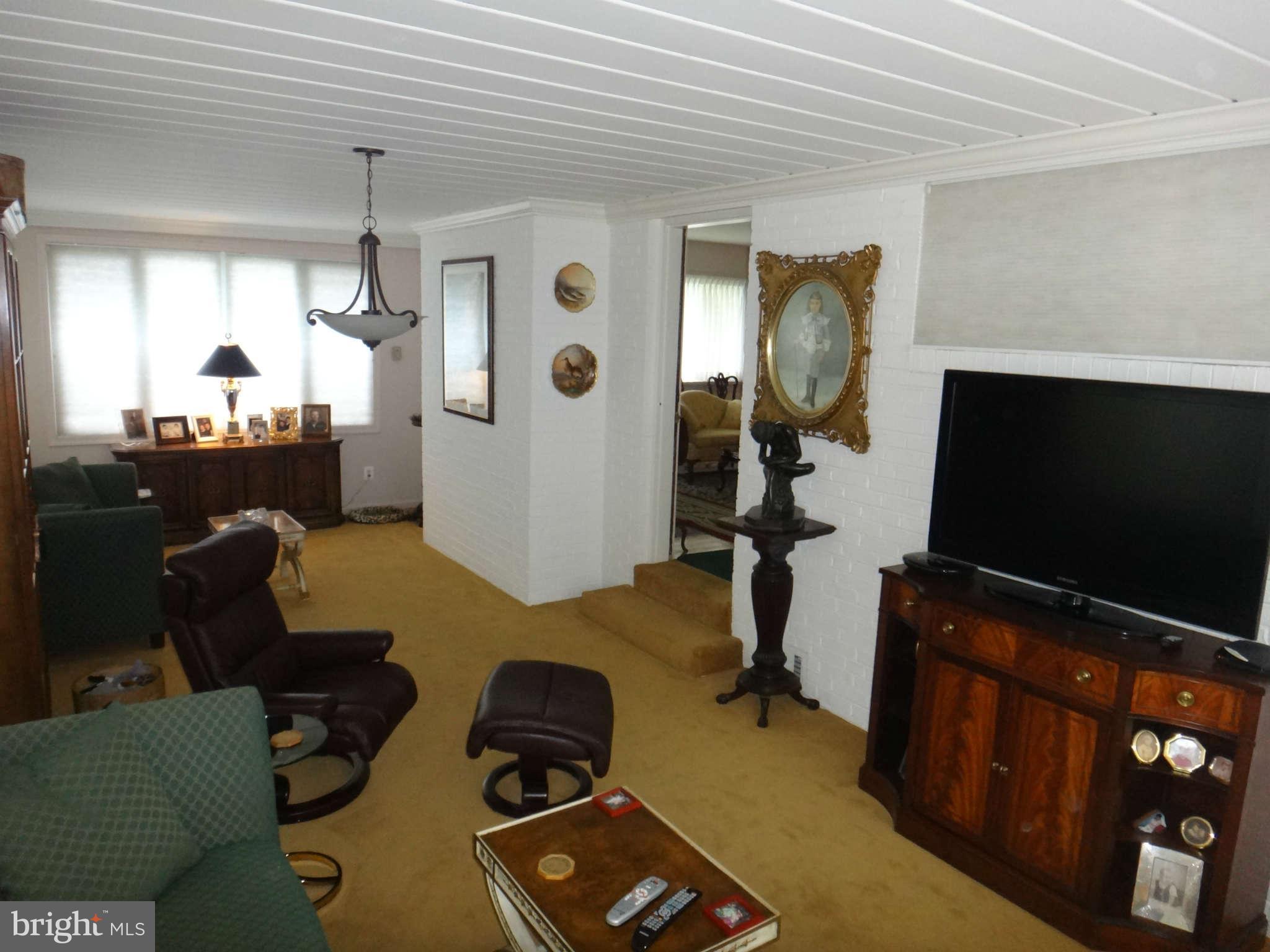 10128 Riggs Road Adelphi, MD 20783 - Photo 15 of 30 a room with furniture and a flat screen tv