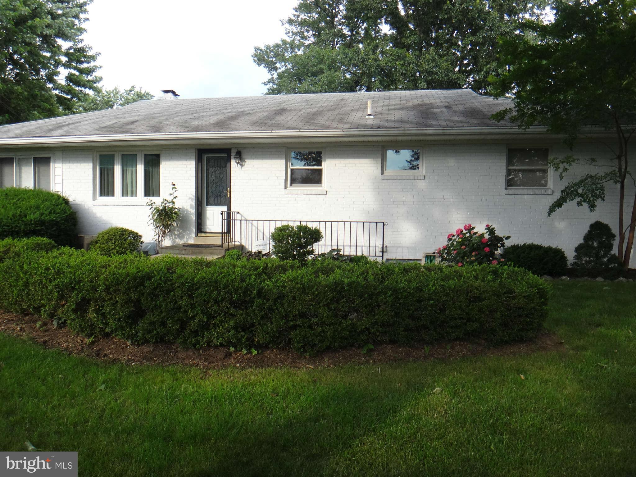 10128 Riggs Road Adelphi, MD 20783 - Photo 28 of 30 a front view of a house with a garden