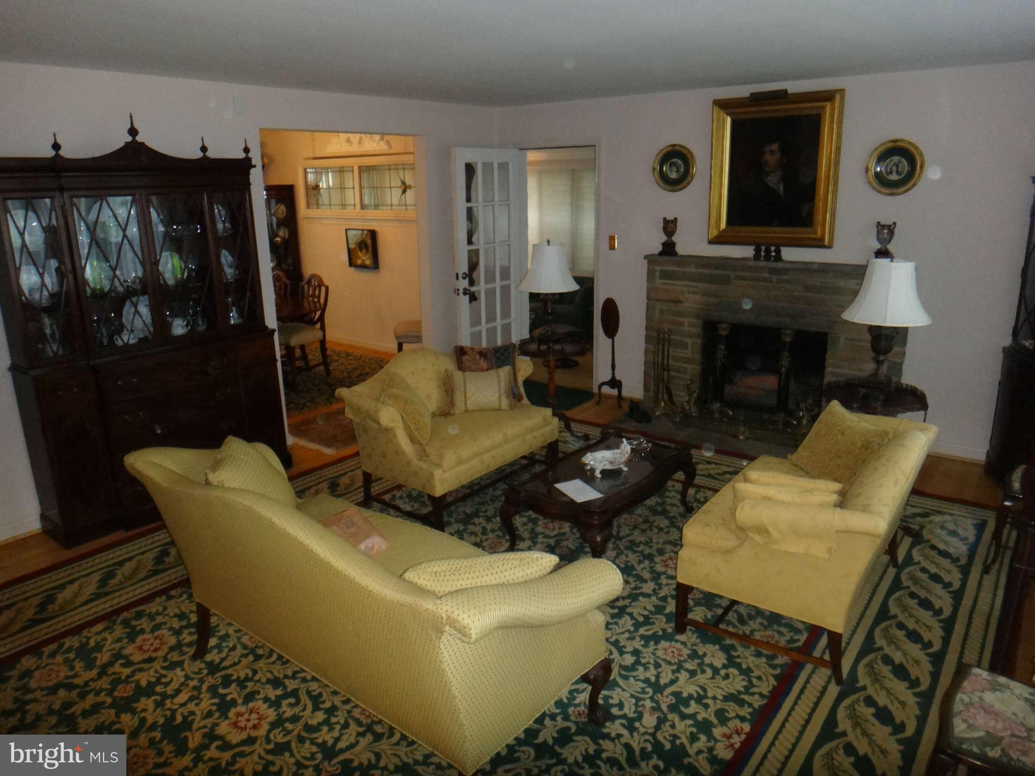 10128 Riggs Road Adelphi, MD 20783 - Photo 6 of 30 a living room with furniture and a fireplace