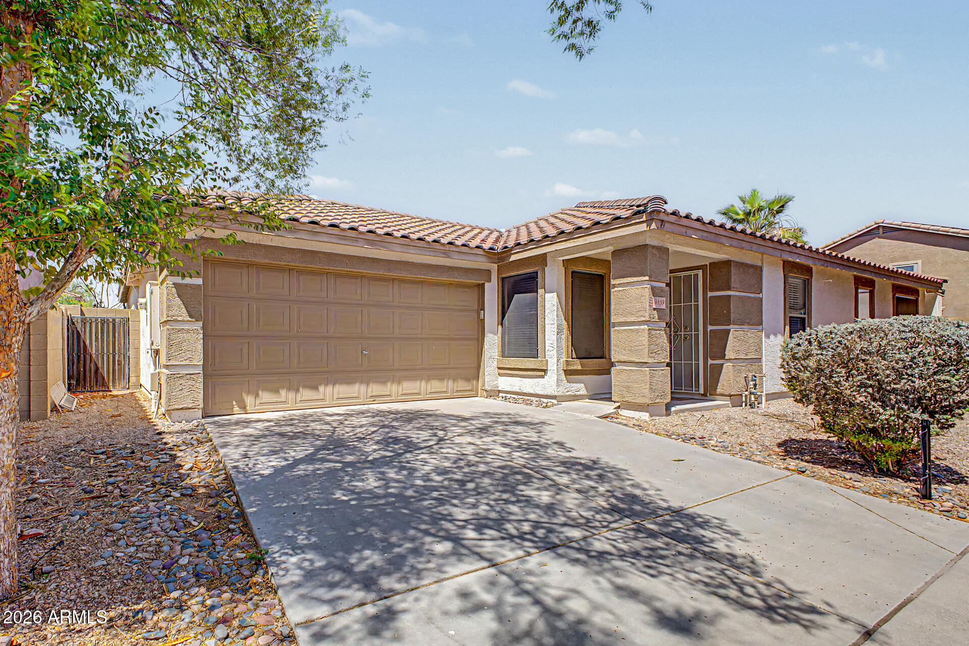3489 South Bowman Road Apache Junction, AZ 85119 - Photo 10 of 24 a front view of a house with a garden