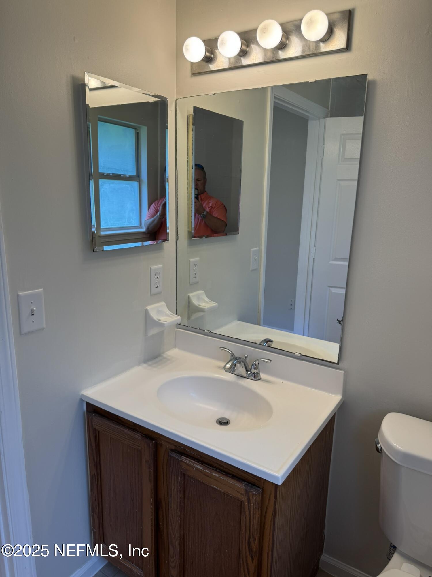 84042 St James Court Yulee, FL 32097 - Photo 19 of 44 a bathroom with a sink vanity and a mirror