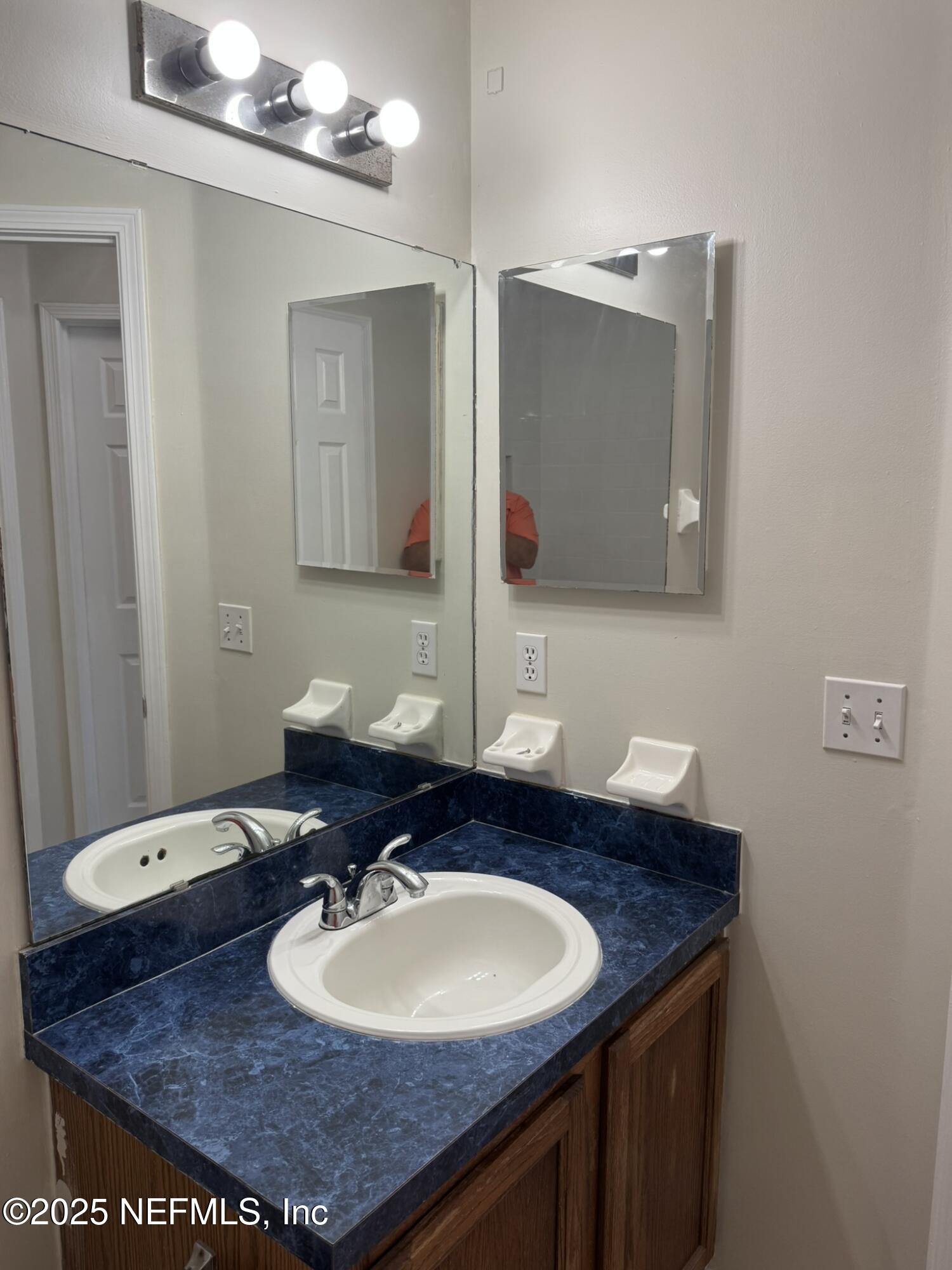 84042 St James Court Yulee, FL 32097 - Photo 23 of 44 a bathroom with a sink and mirror