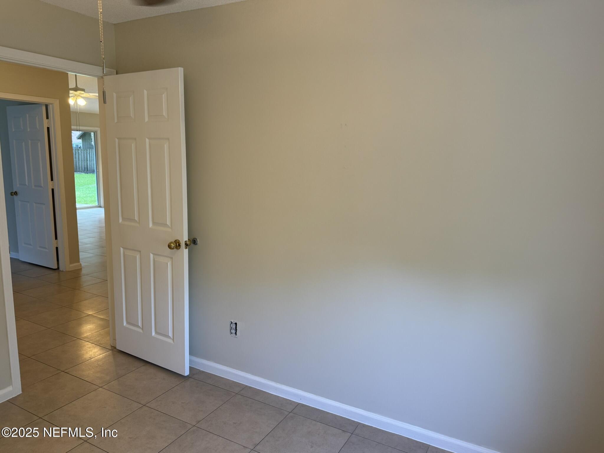 84042 St James Court Yulee, FL 32097 - Photo 26 of 44 an empty room with wooden floor and windows