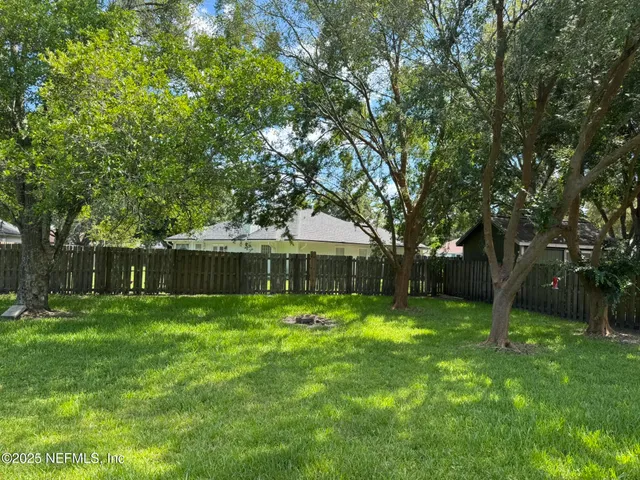 a backyard of a house with lots of green space