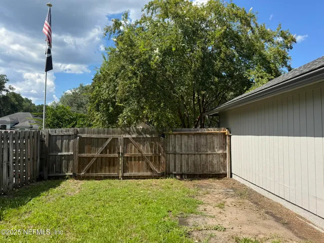 a front view of a house with yard and green space