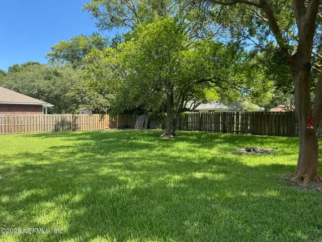 a backyard of a house with table and chairs