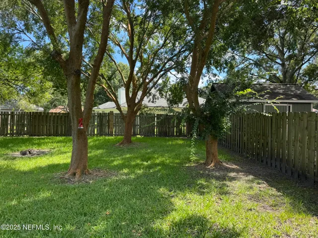 a backyard of a house with lots of green space