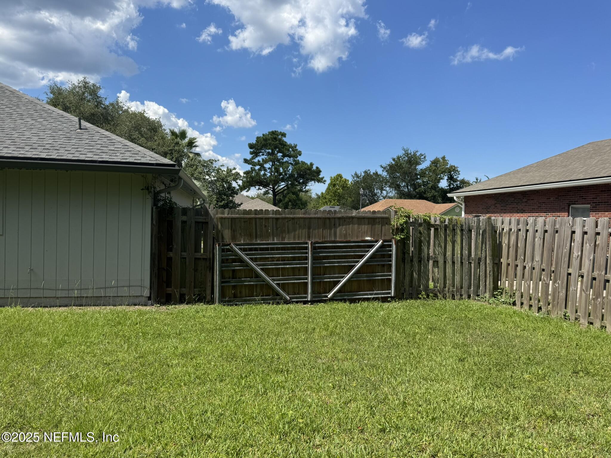84042 St James Court Yulee, FL 32097 - Photo 43 of 44 a backyard of a house with lots of green space