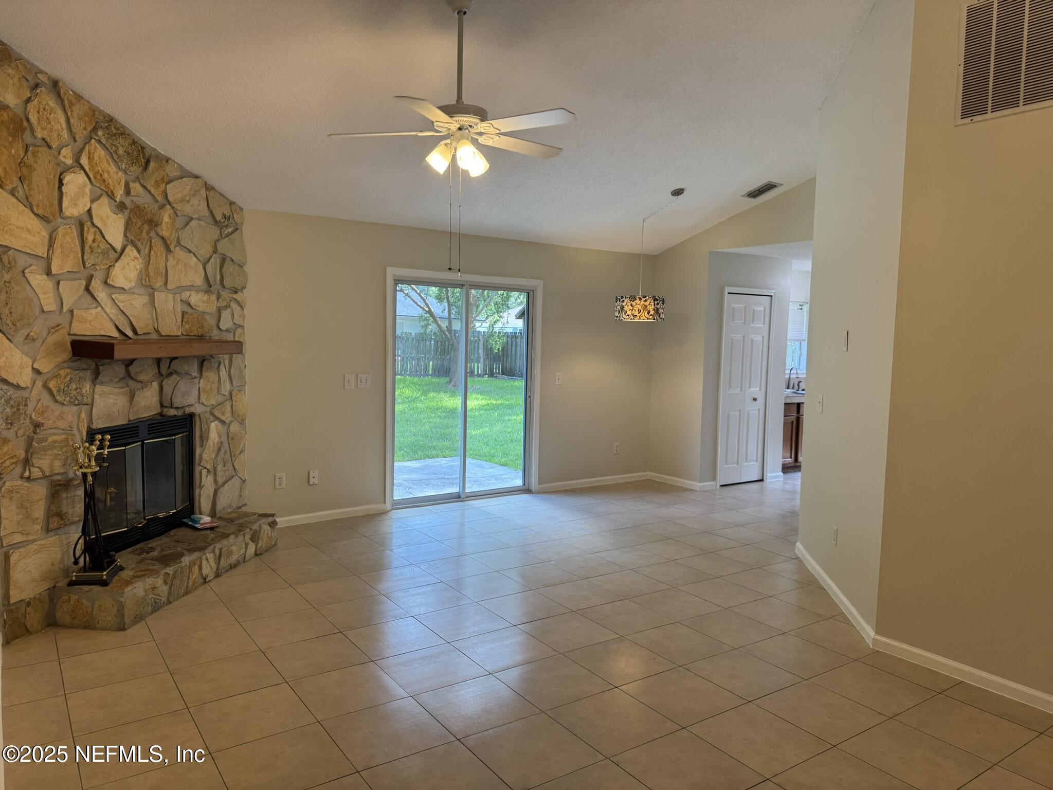 84042 St James Court Yulee, FL 32097 - Photo 7 of 44 a view of an empty room with a fireplace