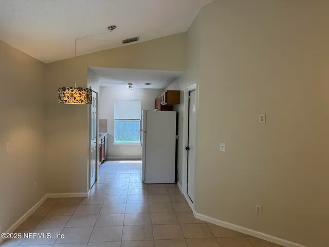 a kitchen with a sink stove and mirror