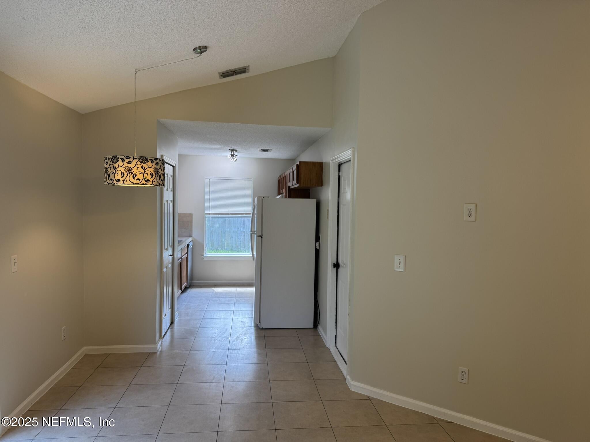84042 St James Court Yulee, FL 32097 - Photo 9 of 44 a view of a hallway with a kitchen