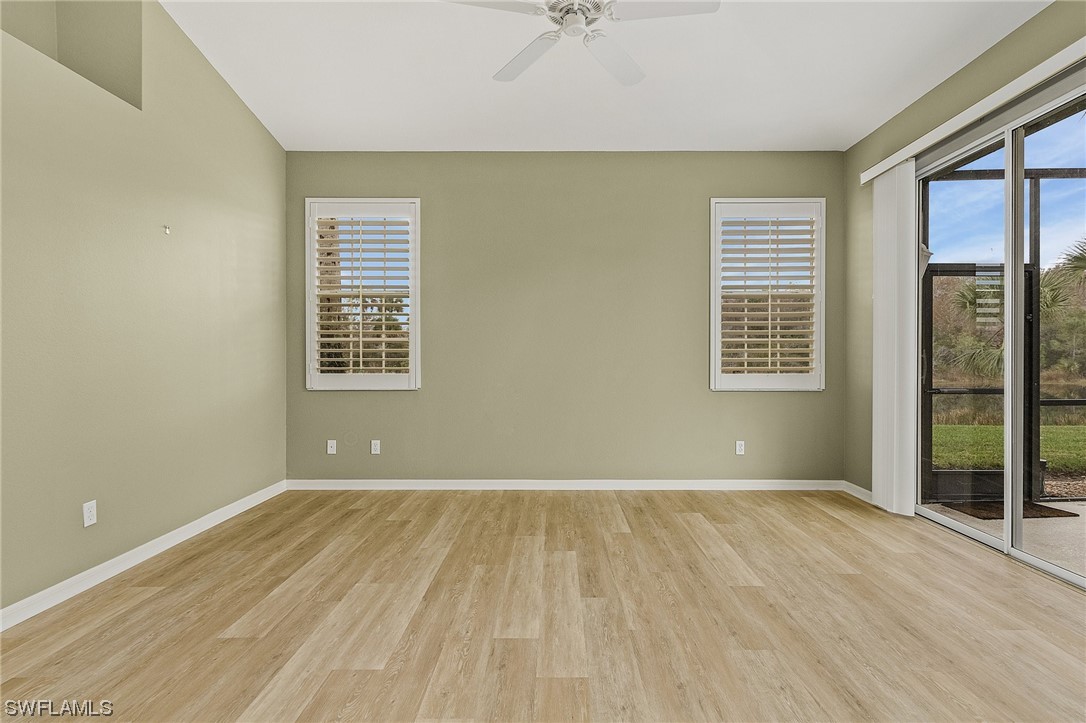 10321 Cape Roman Road, Unit 102 Estero, FL 34135 - Photo 16 of 33 a view of an empty room with a window and wooden floor