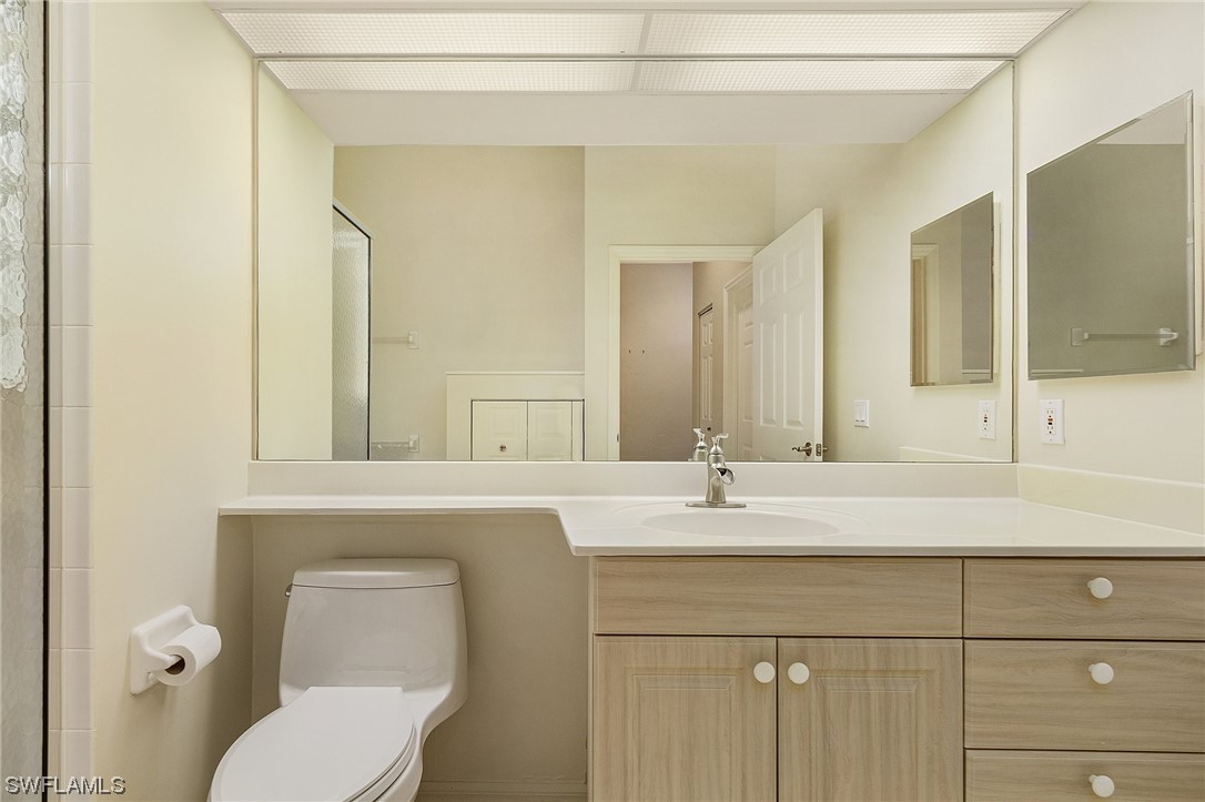 10321 Cape Roman Road, Unit 102 Estero, FL 34135 - Photo 21 of 33 a bathroom with a sink and a mirror