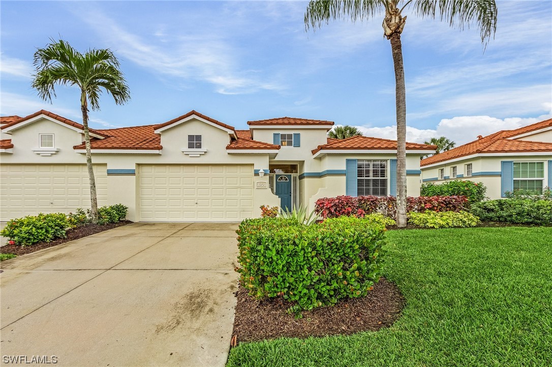 10321 Cape Roman Road, Unit 102 Estero, FL 34135 - Photo 22 of 33 a front view of a house with a garden