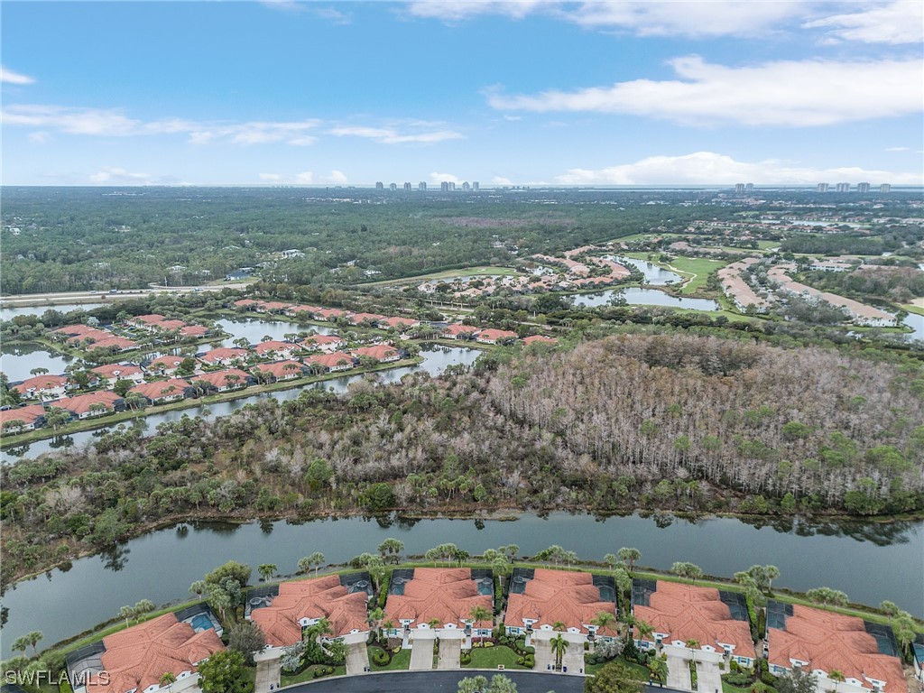 10321 Cape Roman Road, Unit 102 Estero, FL 34135 - Photo 27 of 33 an aerial view of residential building and lake