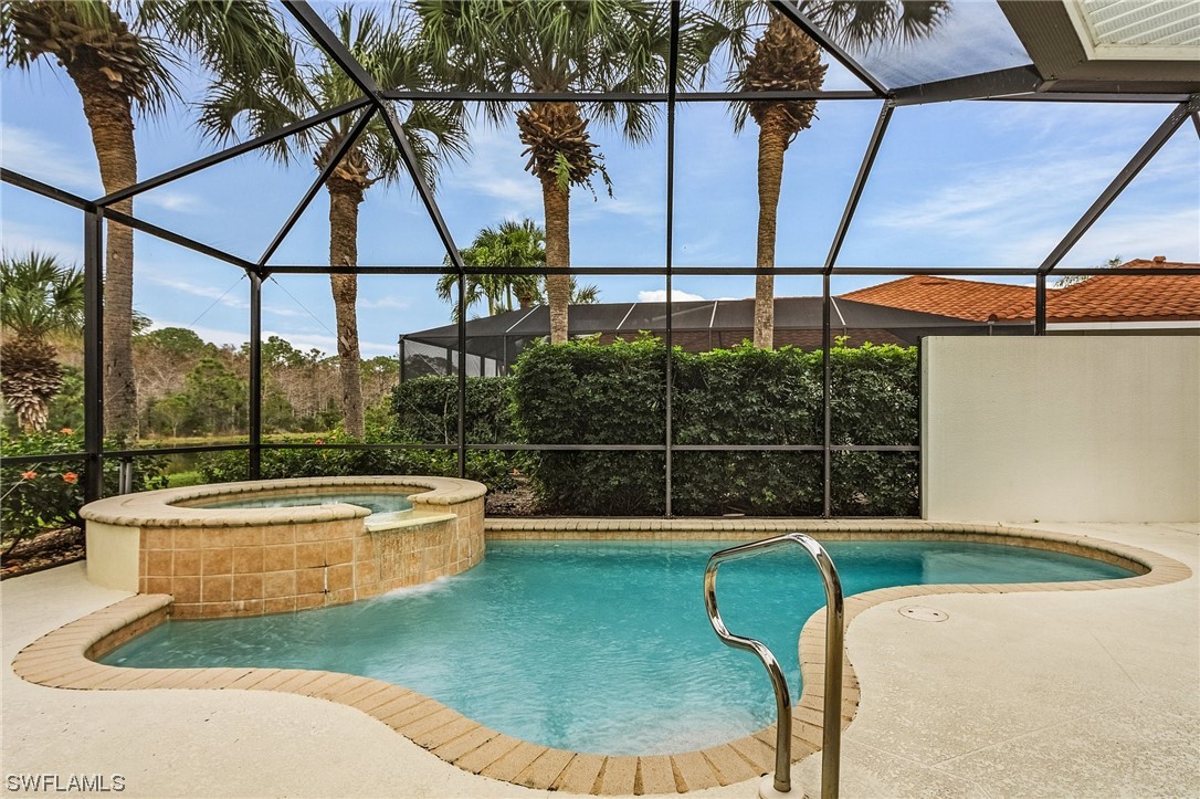 10321 Cape Roman Road, Unit 102 Estero, FL 34135 - Photo 3 of 33 a backyard of a house with fountain table and chairs