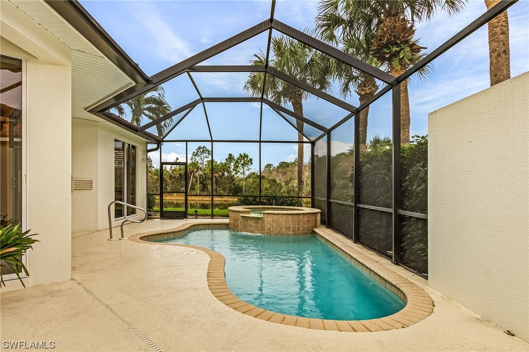 10321 Cape Roman Road, Unit 102 Estero, FL 34135 - Photo 4 of 33 a view of a swimming pool with a lounge chairs