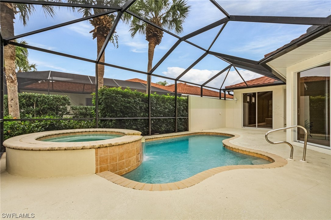 10321 Cape Roman Road, Unit 102 Estero, FL 34135 - Photo 5 of 33 a view of a white house with swimming pool