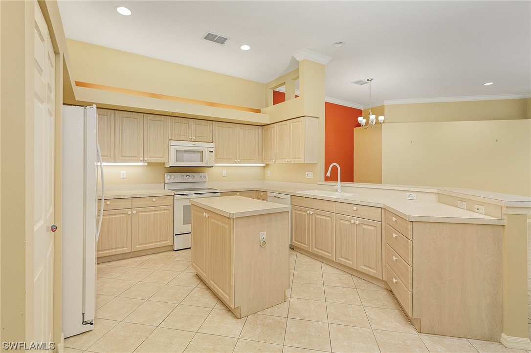 10321 Cape Roman Road, Unit 102 Estero, FL 34135 - Photo 7 of 33 a kitchen with a sink and cabinets