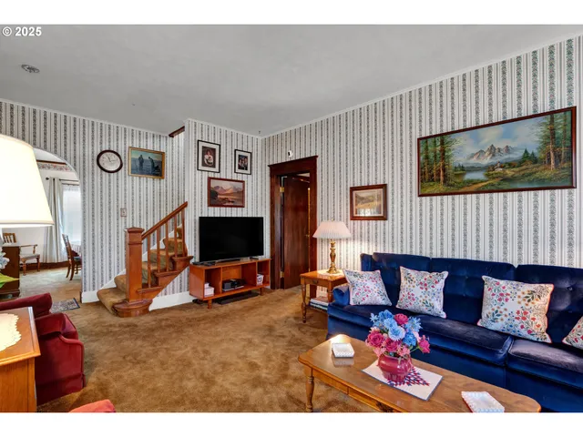 a living room with furniture a rug and a chandelier
