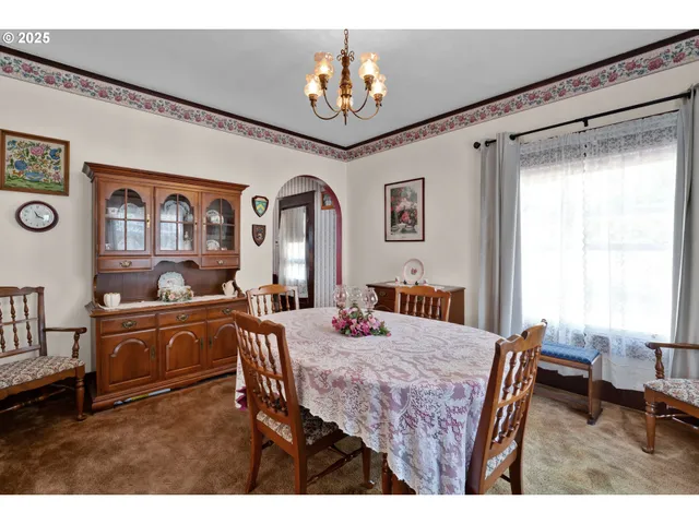 a kitchen with stainless steel appliances granite countertop a stove a sink dishwasher and a refrigerator with wooden floor