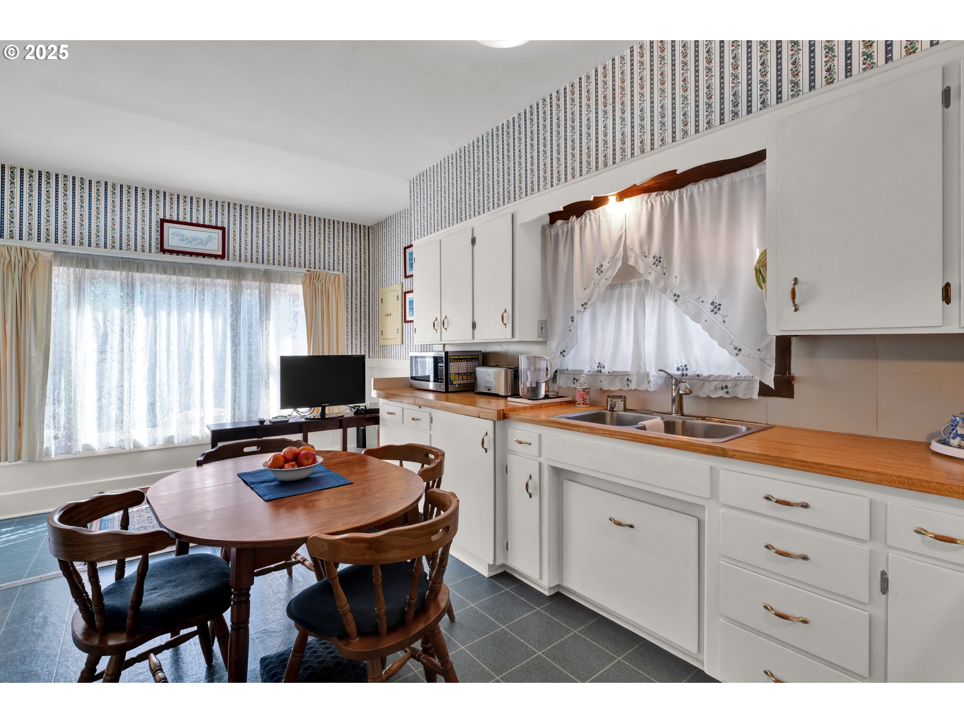 834 Southwest 9th Avenue Albany, OR 97321 - Photo 21 of 48 a kitchen with stainless steel appliances a table chairs and a refrigerator