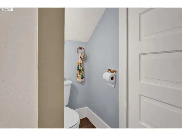 a bedroom with a bed and a dresser next to a window