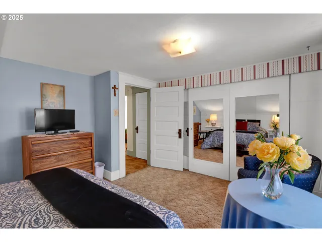 a bedroom with a large bed and lamp