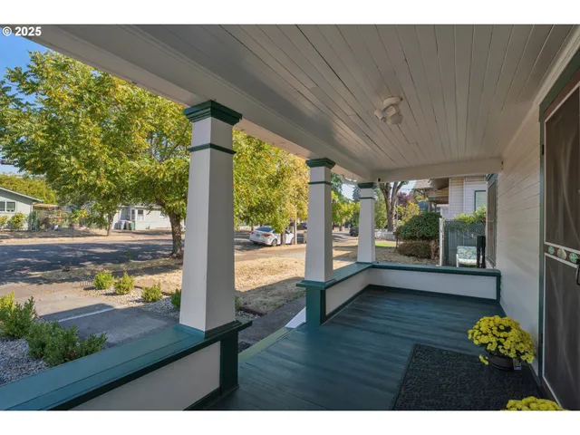 a kitchen view with wooden floor and a dining table