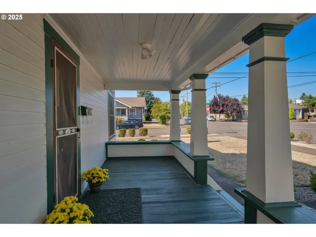 a backyard of a house with table and chairs