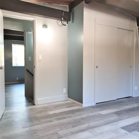 a view of a room with wooden floor