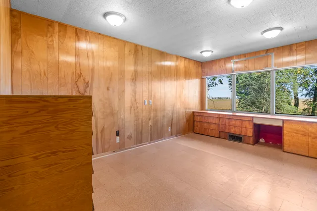 en empty room with large windows