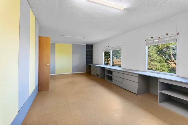 a view of room with window and furniture