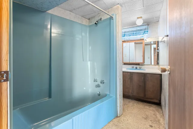 a bathroom with a bathtub and a shower