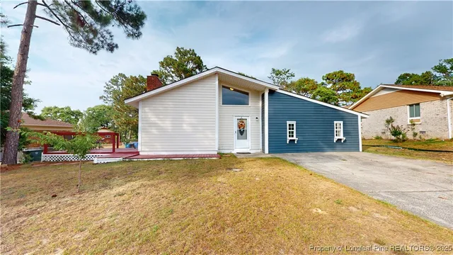 a view of a house with a yard and garage