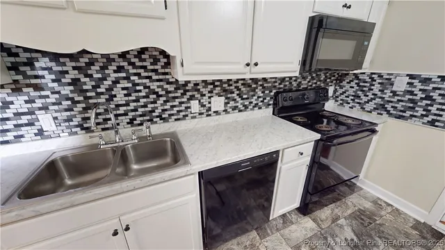 a kitchen with a sink a stove and a microwave