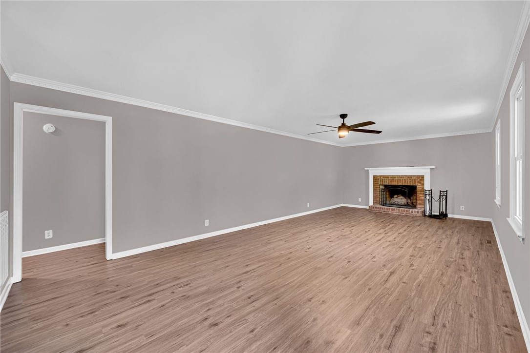1509 Crestview Road Easley, SC 29642 - Photo 2 of 31 This expansive living area features elegant hardwood flooring and a cozy fireplace, perfect for gatherings.