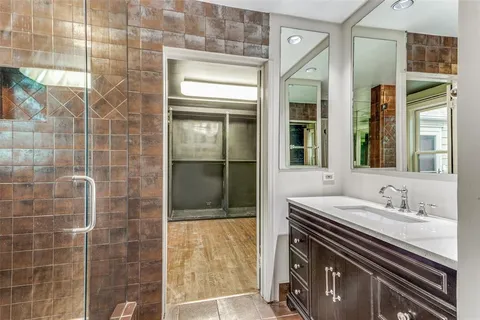 a bathroom with a sink a mirror and a shower