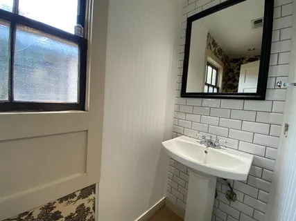a bathroom with a sink a mirror and a window