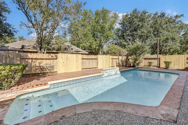 a view of a swimming pool with a yard