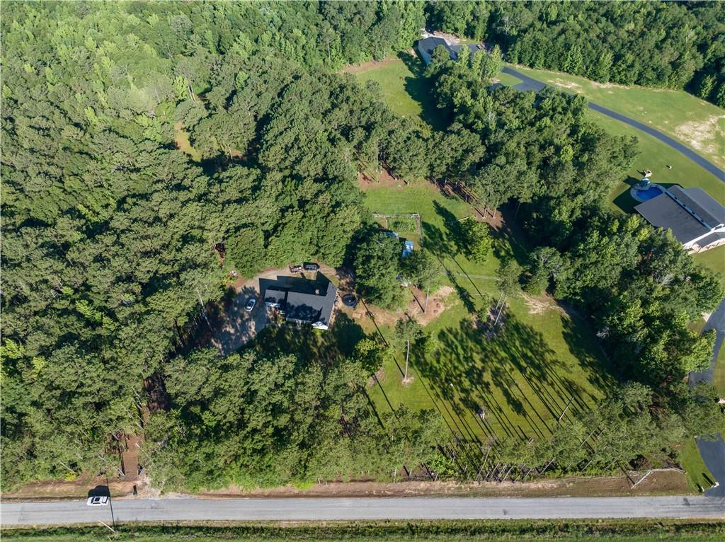 62 McCarthy Road Opelika, AL 36804 - Photo 56 of 74 Expansive property featuring a single-story residence with a dark roof, surrounded by extensive mature tree coverage