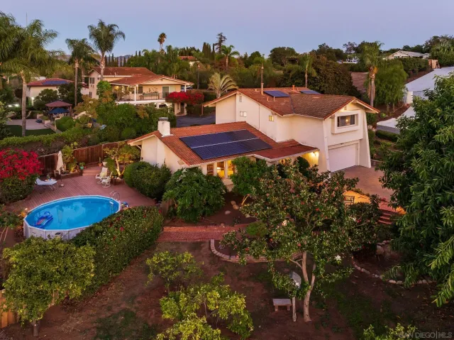 an aerial view of a house with yard swimming pool and outdoor seating