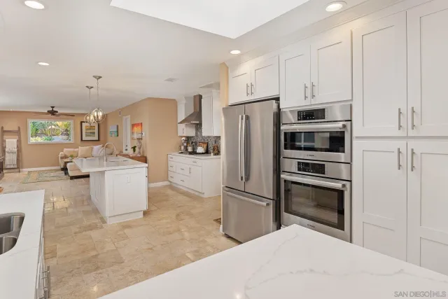 a kitchen with stainless steel appliances a refrigerator and a stove top oven