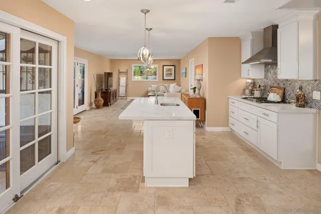 a view of a room with a large window and front door