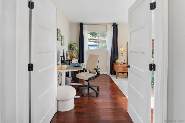 a bedroom with a bed and painting on the wall
