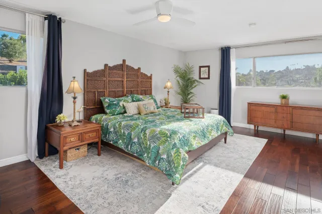 a bedroom with a bed and a potted plant