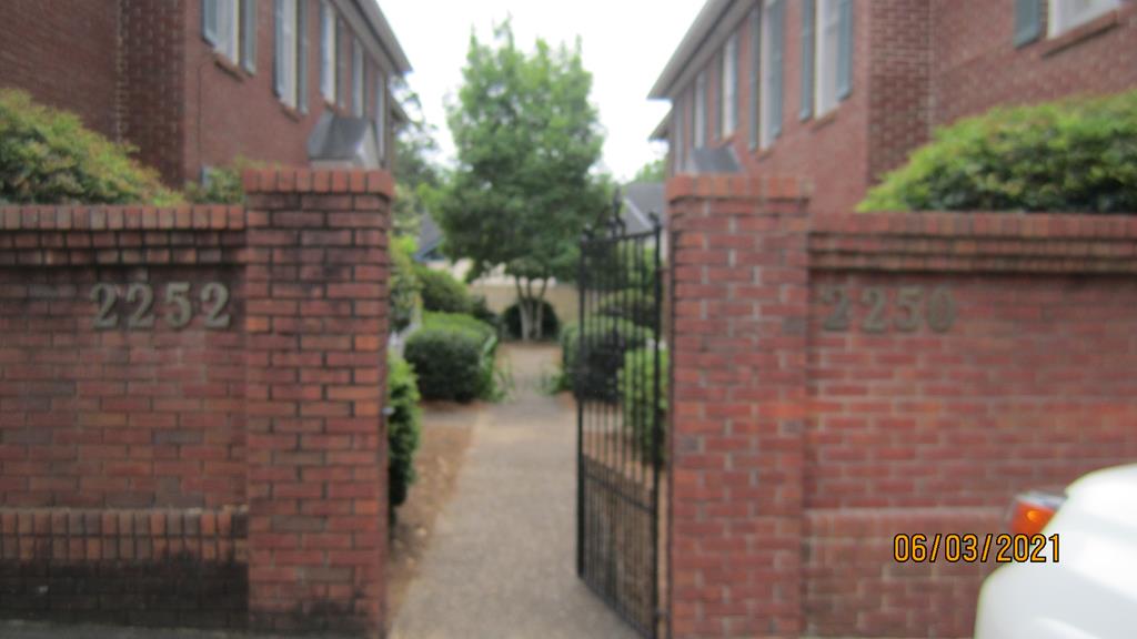a pathway of a house with a yard
