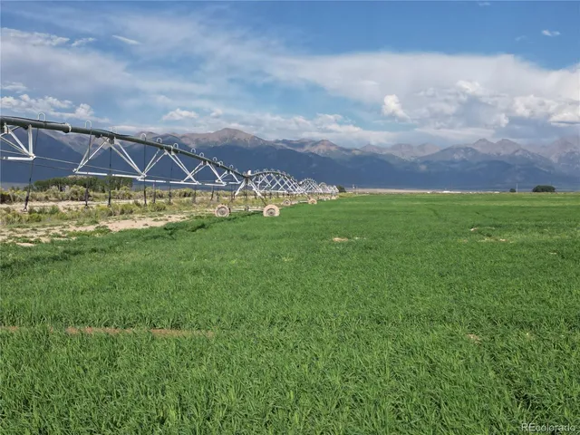 a view of a big house with a big yard and a large tree
