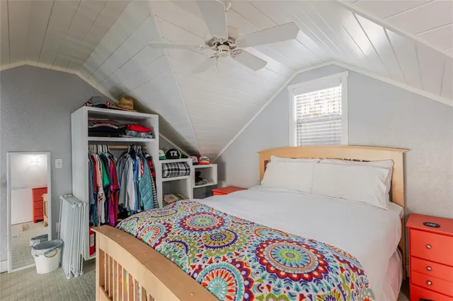 a bedroom with a large bed and a book shelf