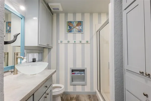 a bathroom with a sink a toilet and shower curtain